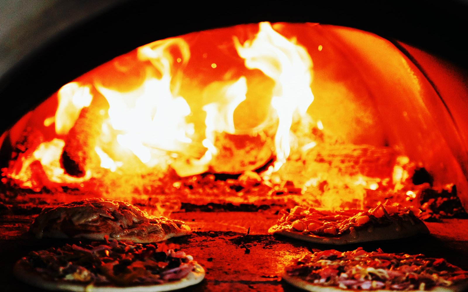 Cross Country Pizza wood-fired pizza trailer at dusk